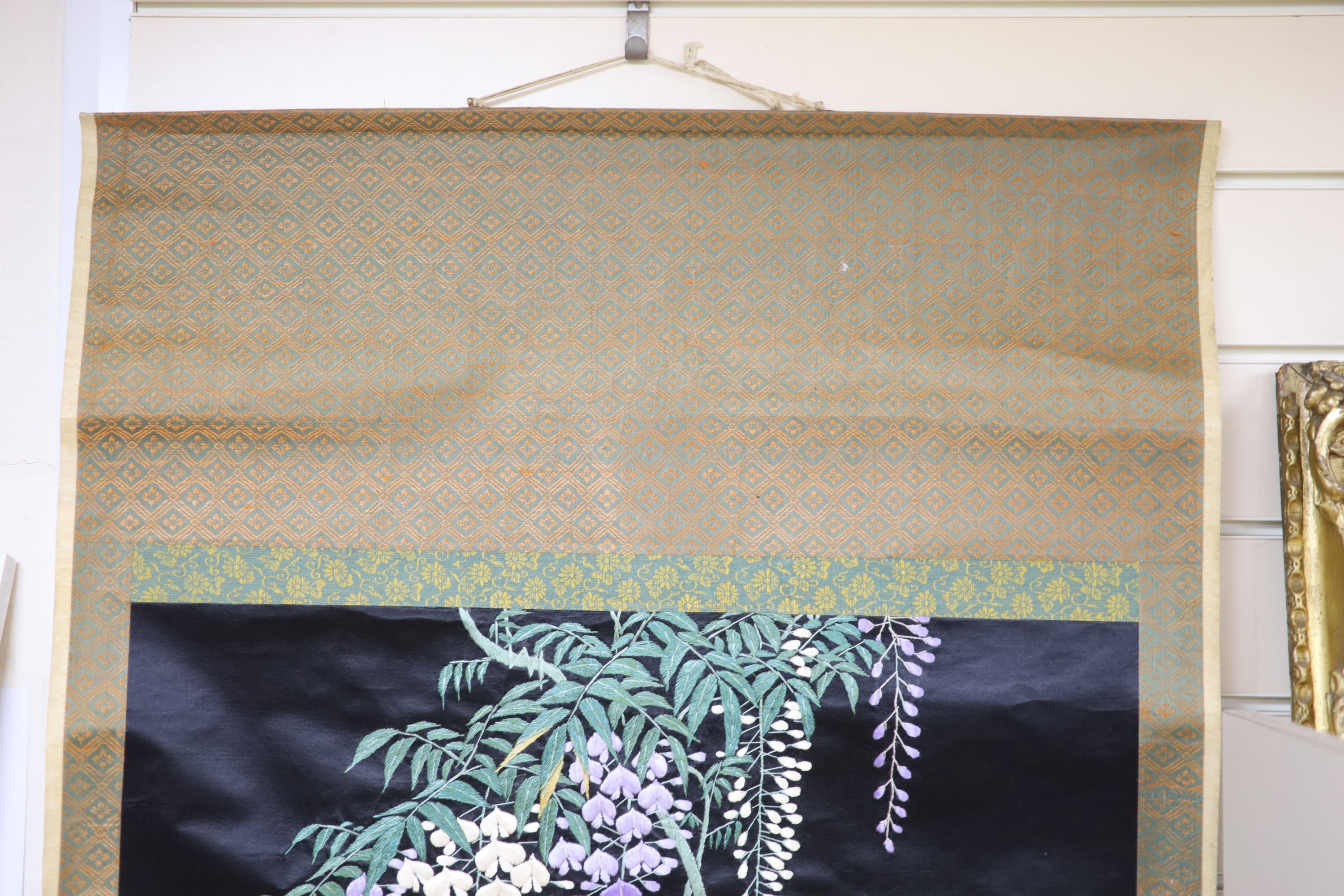 A Japanese embroidered wisteria hanging scroll, overall length 170cm